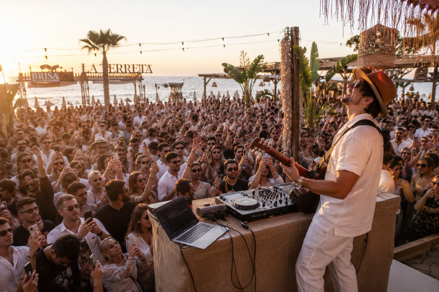 Tom Panizza performing live with a packed crowd at sunset